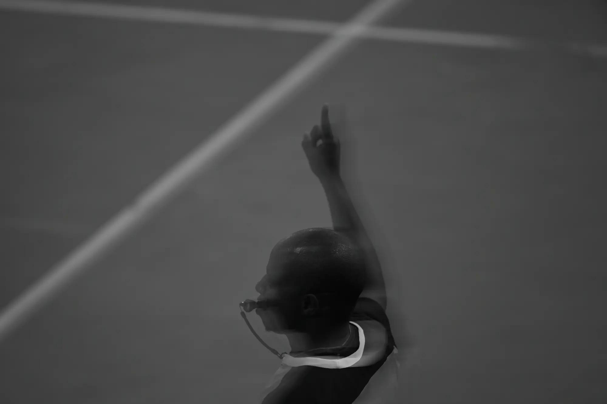 An official raises one finger for a single free throw, alone on the empty painted floor