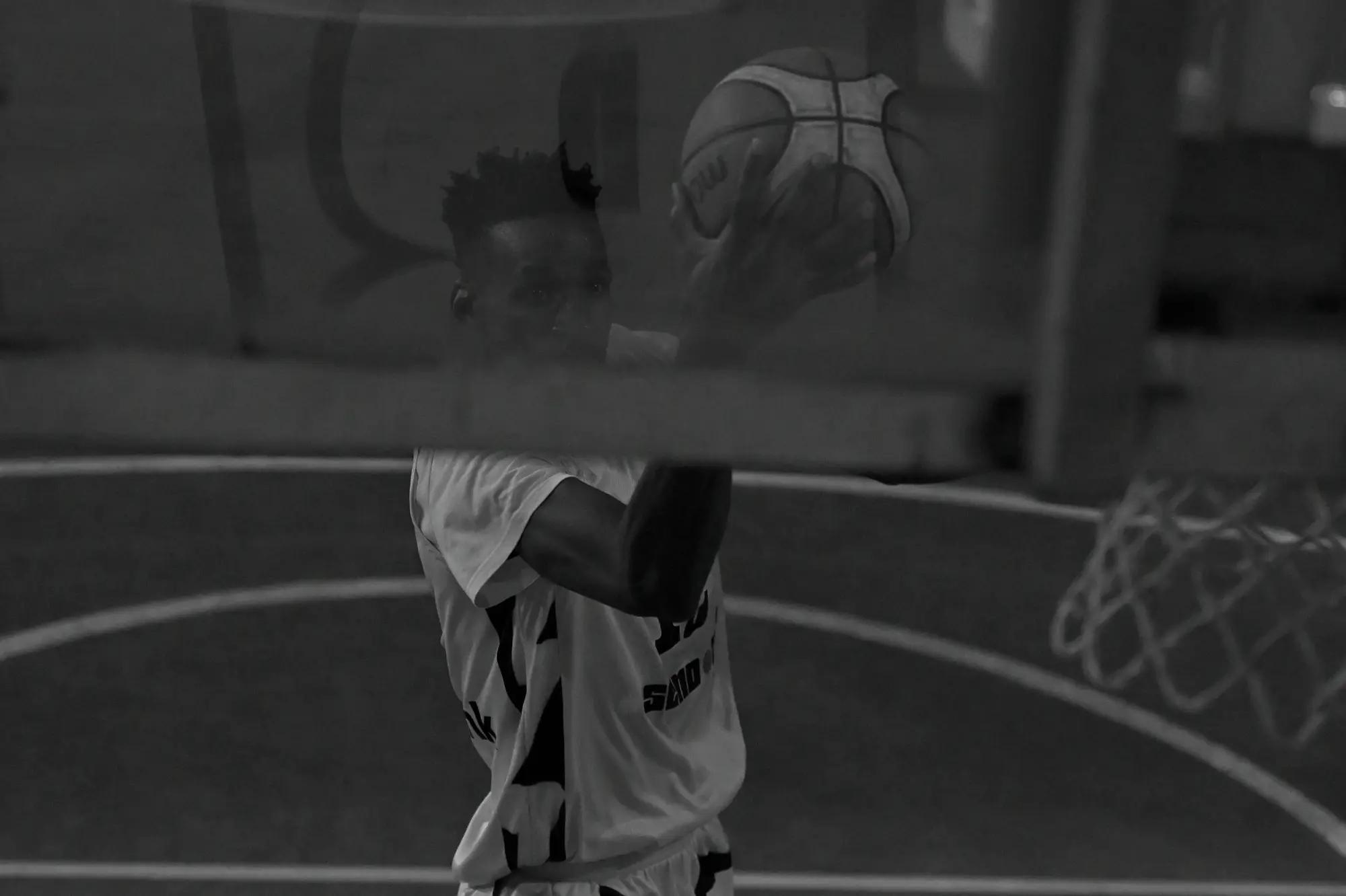 A Thunder player sights the rim above a barrier rail that cuts straight across the frame