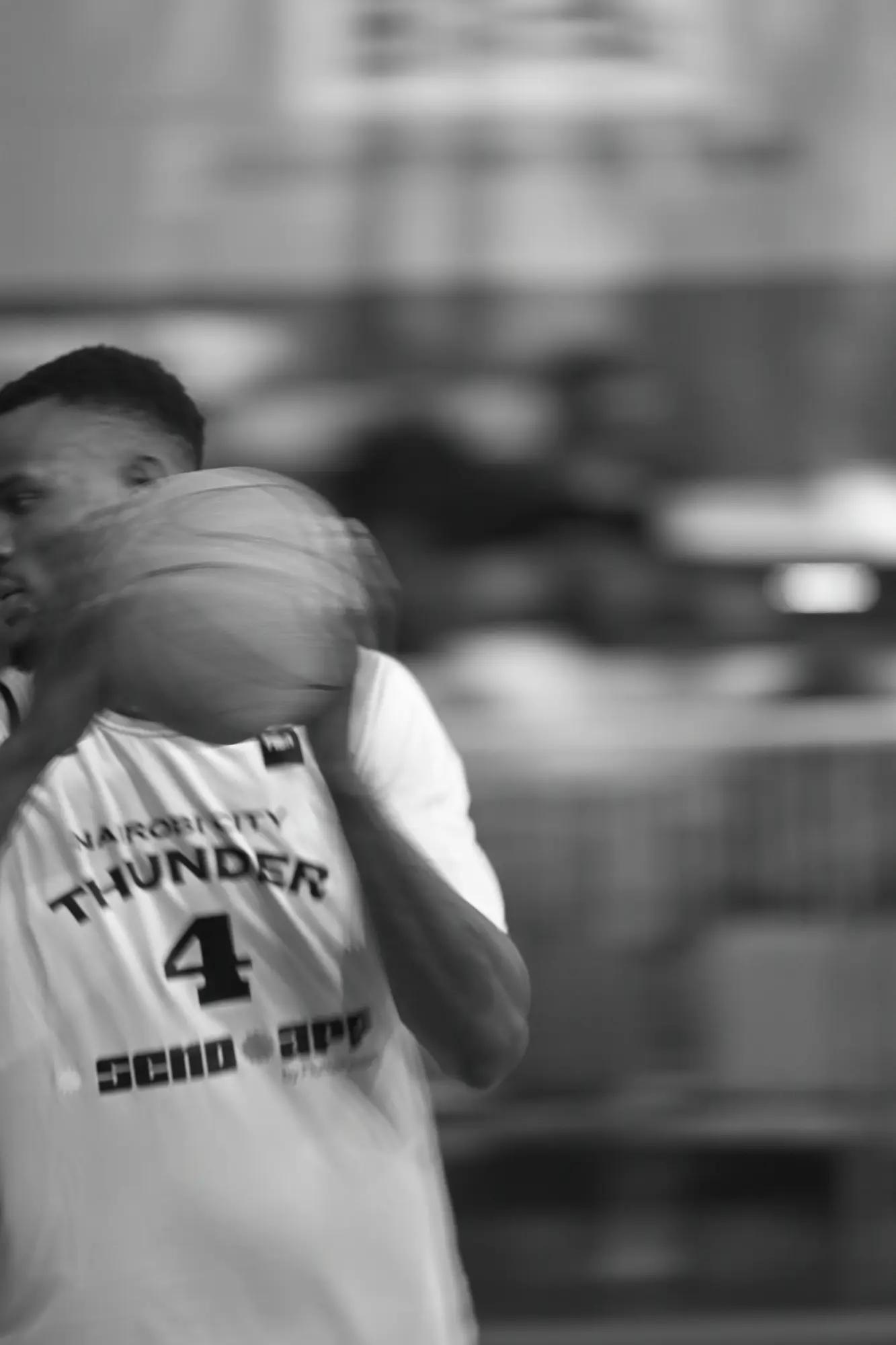 Nairobi City Thunder's number four winding up, the ball smeared to a blur across his face