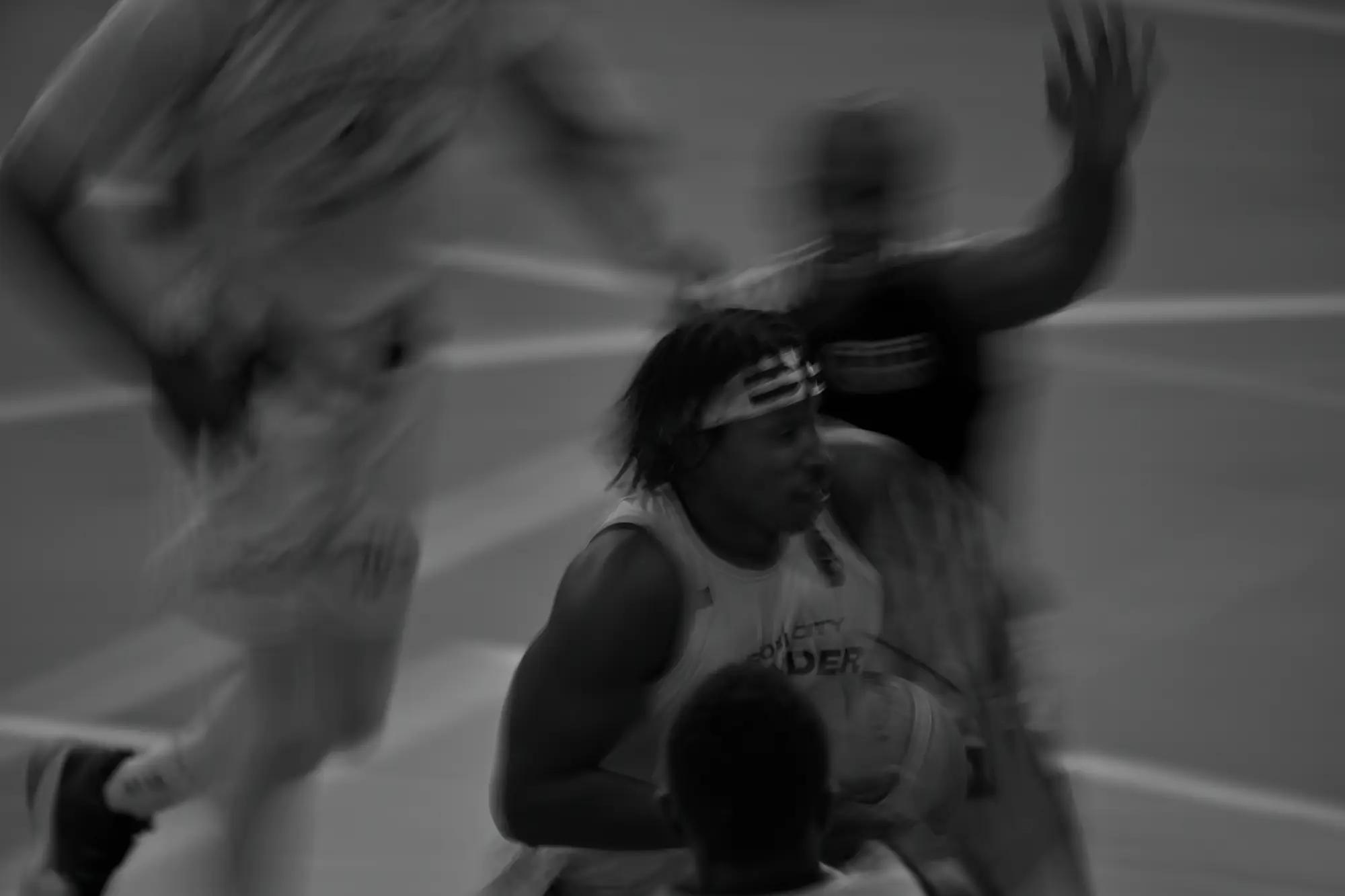 A player in a striped headband holds still while the whole frame streaks past him
