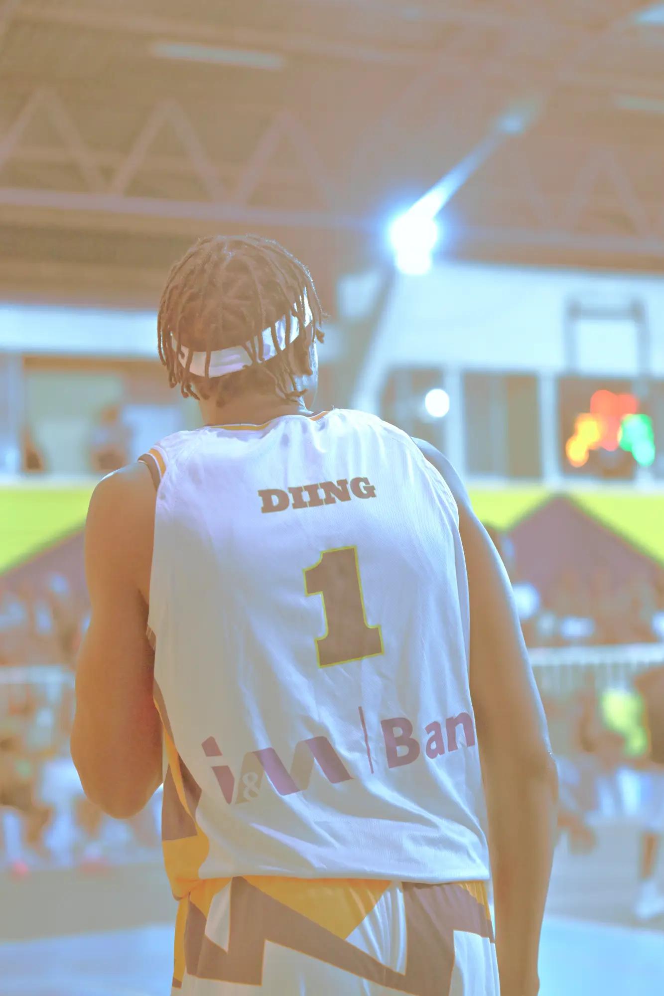 High-key bleached frame of Nairobi City Thunder's number one on court, arena light blown to near-white